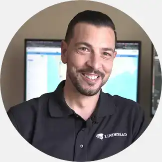 Matt Witte, Head of Piano Sales at Lindeblad, with a friendly expression, in a black Lindeblad branded polo, demonstrating professional customer service