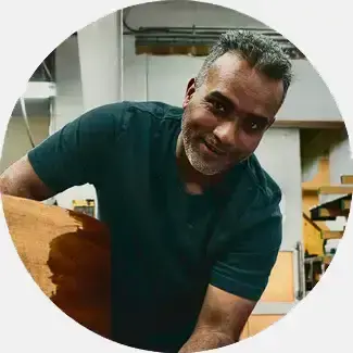 Mohamed Kayume, Color Matching Master Craftsman, engaged in his craft of piano refinishing, with eight years of experience at Steinway before coming to Lindeblad