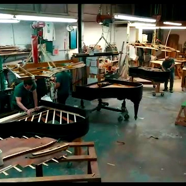 Lindeblad workshop floor with craftsmen restoring grand pianos