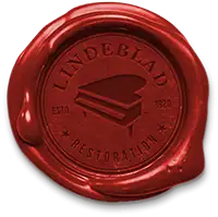 Wax seal with Lindeblad Piano Restoration's logo symbolizing care and professionalism.