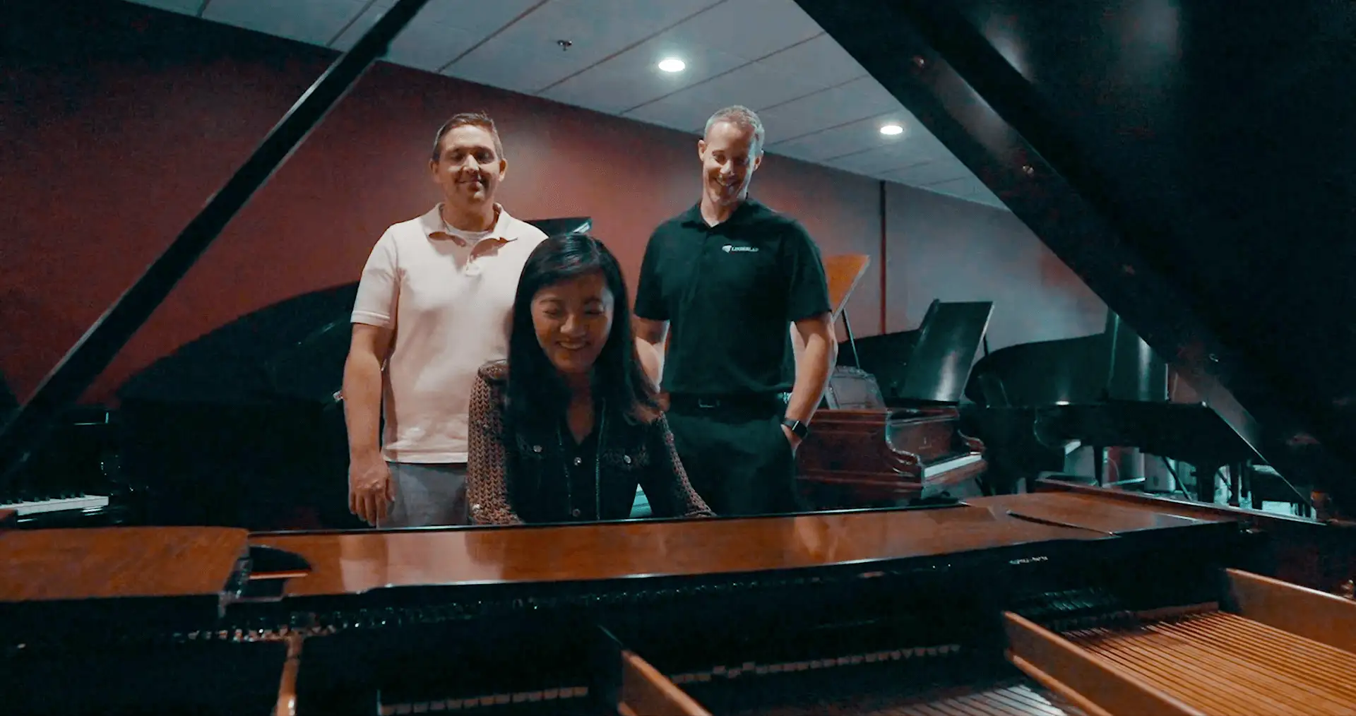 Customers around a piano in the showroom