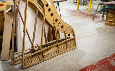 Two cast iron piano harps waiting to be refinished.